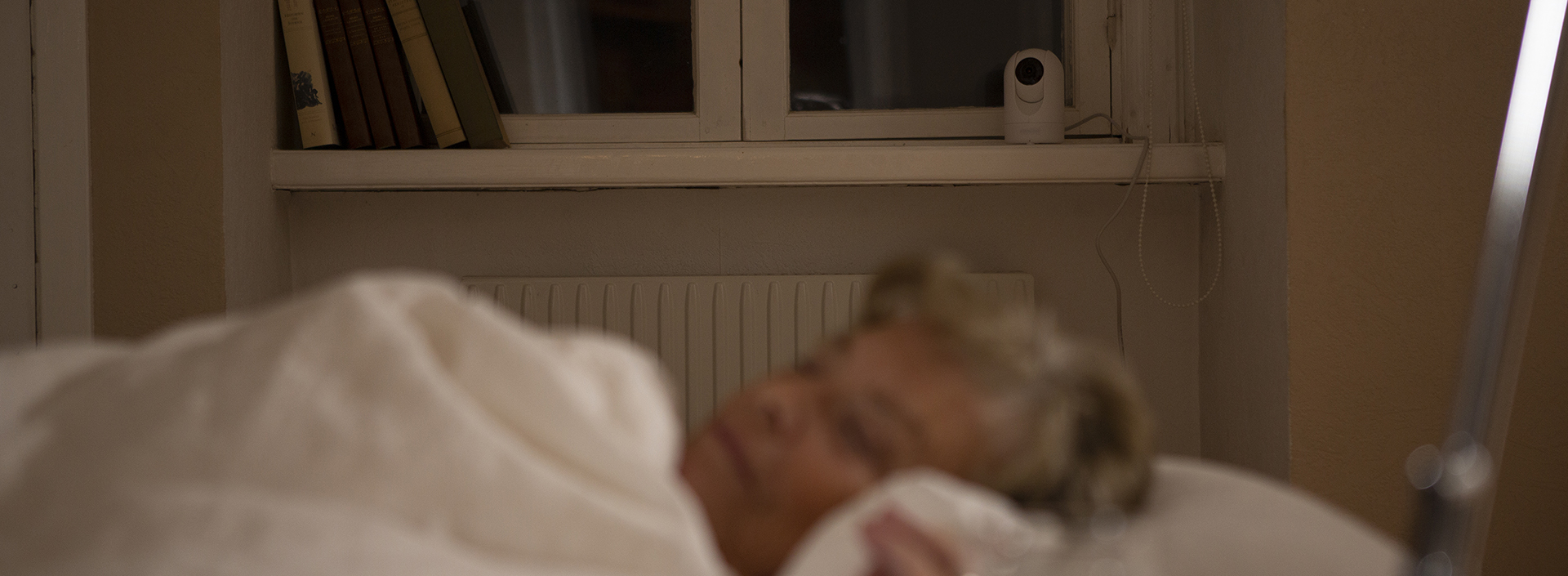 Monitoring via camera of a lady sleeping in bed