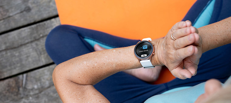 Senior using Doro smartwatch during exercise showing health and activity tracking