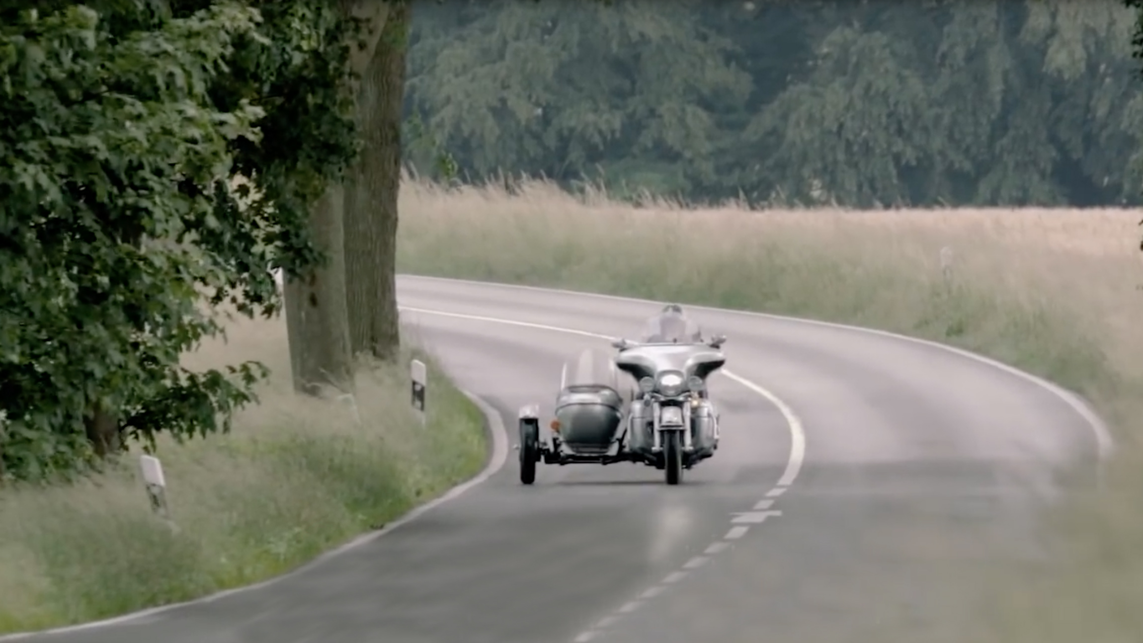 Norbert riding his motorcycle on a country road