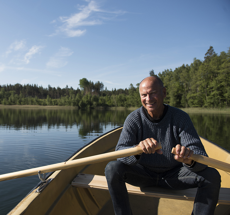 Lasse Holm rowing a boat on a lake. 