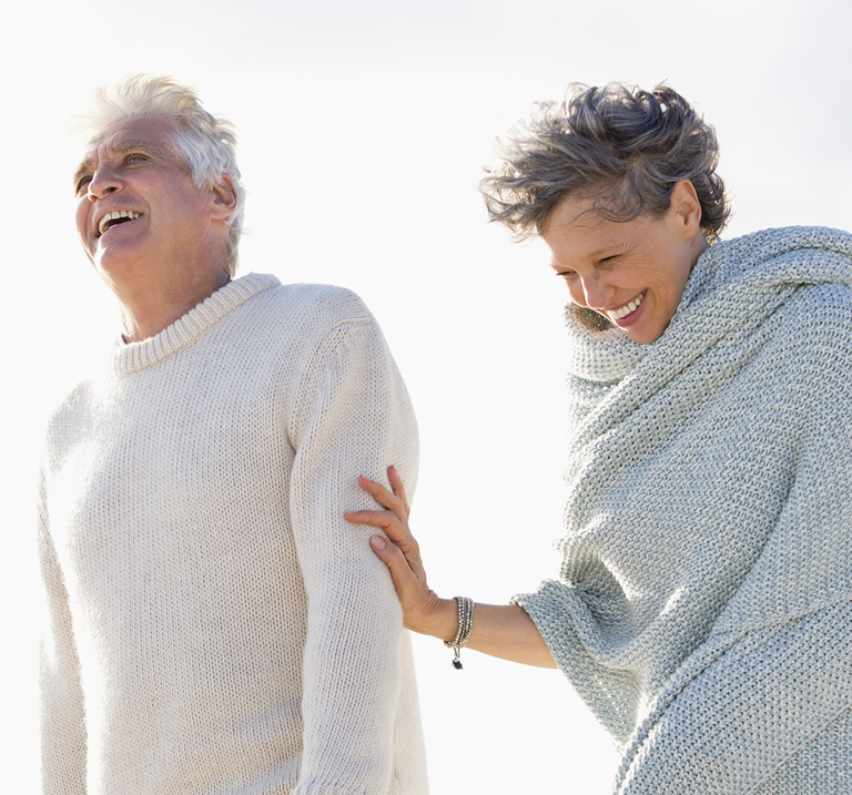 Couple outdoors, laughing.