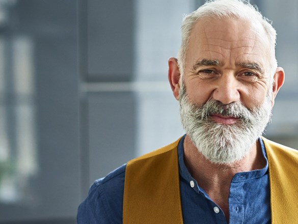 Man in blue shirt and vest.